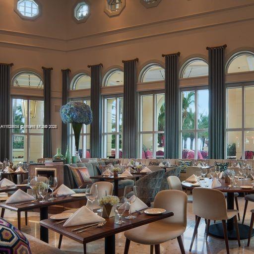 dining area with a healthy amount of sunlight and a high ceiling