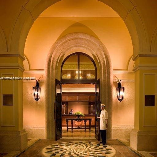 interior space featuring decorative columns and arched walkways