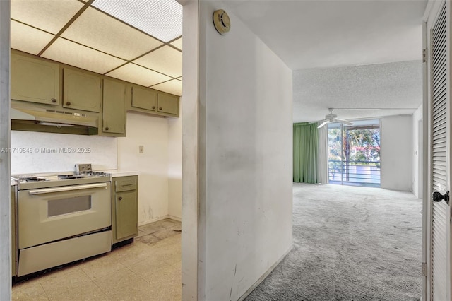 kitchen featuring stove, a drop ceiling, ceiling fan, and green cabinetry