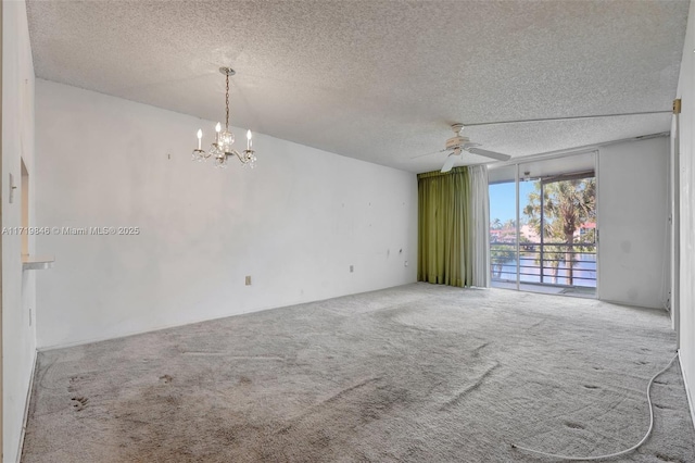 unfurnished room with carpet flooring, ceiling fan with notable chandelier, and a textured ceiling