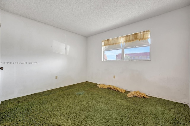 carpeted spare room featuring a textured ceiling