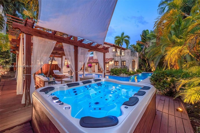 view of swimming pool featuring a hot tub and a wooden deck