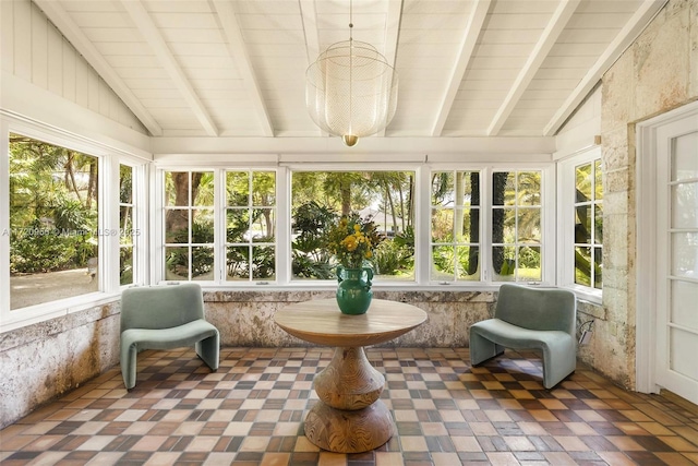 sunroom / solarium featuring vaulted ceiling with beams and plenty of natural light