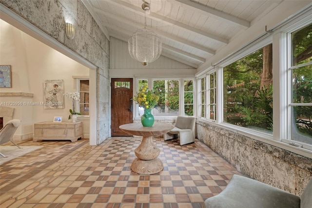 sunroom featuring vaulted ceiling with beams, a premium fireplace, and wooden ceiling