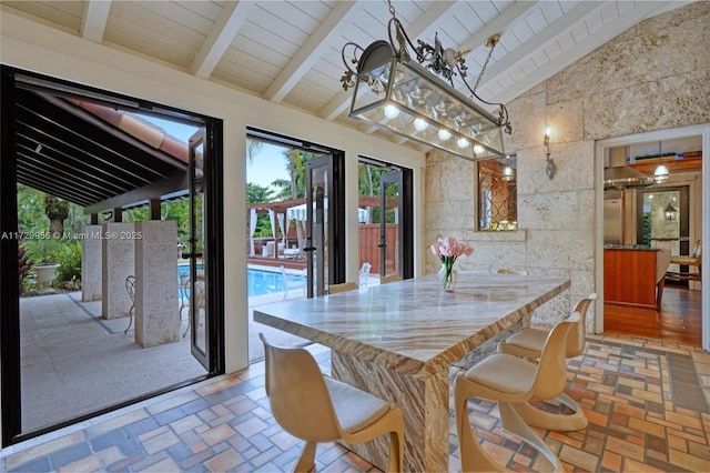 dining area with brick floor, wood ceiling, high vaulted ceiling, and beamed ceiling