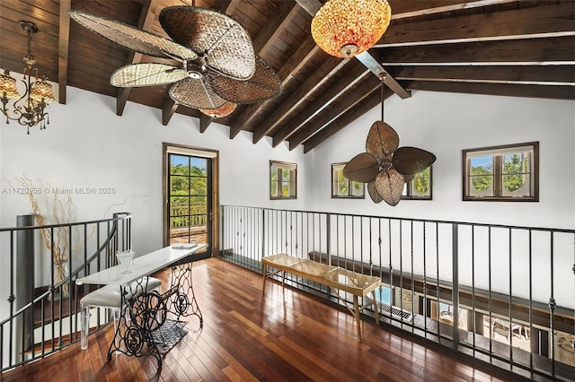 interior space featuring lofted ceiling with beams, wood ceiling, wood finished floors, and an upstairs landing