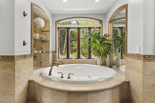 bathroom featuring a garden tub, tile walls, and recessed lighting