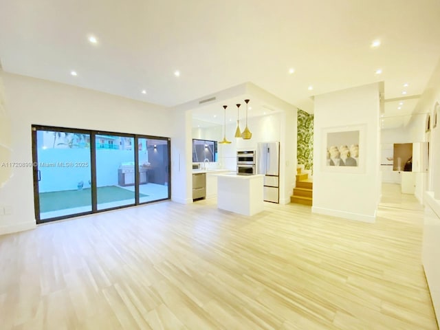 unfurnished living room featuring light hardwood / wood-style floors