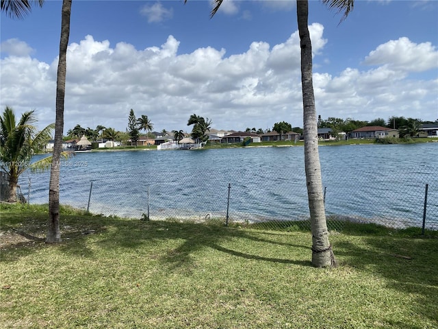 property view of water with fence and a residential view