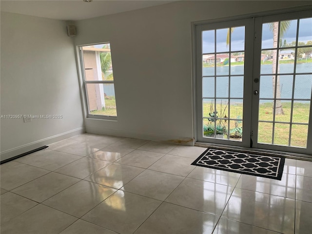 doorway with light tile patterned floors