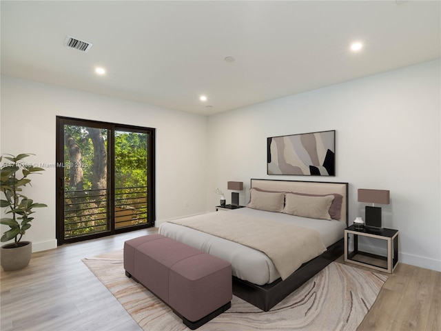 bedroom featuring access to outside and light wood-type flooring