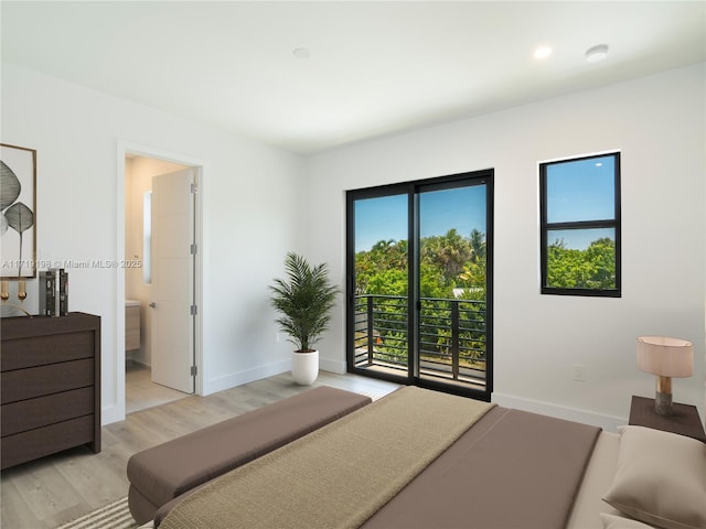 bedroom featuring access to exterior, light hardwood / wood-style flooring, and ensuite bath