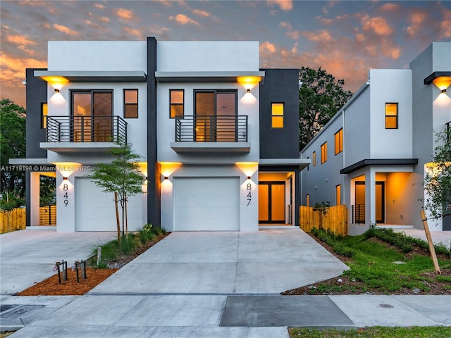 modern home with a balcony and a garage