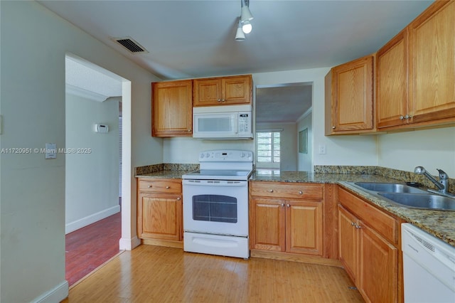 kitchen with light wood-type flooring, white appliances, crown molding, sink, and stone countertops