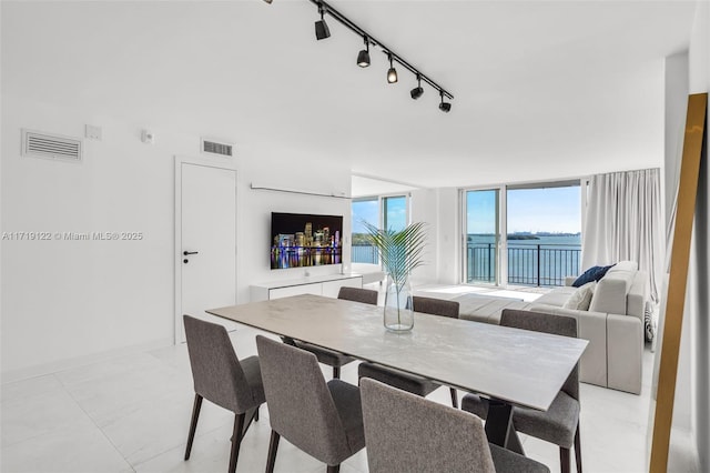 dining room with track lighting and floor to ceiling windows