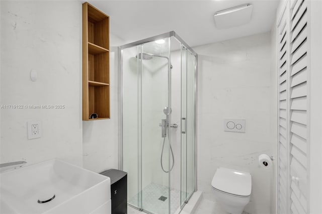 bathroom with vanity, toilet, and a shower with door