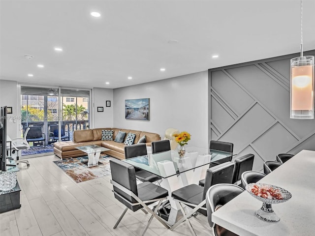 dining area featuring floor to ceiling windows and light hardwood / wood-style flooring