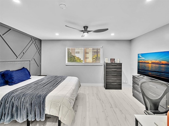 bedroom with light hardwood / wood-style floors and ceiling fan