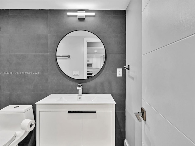 bathroom featuring vanity and toilet