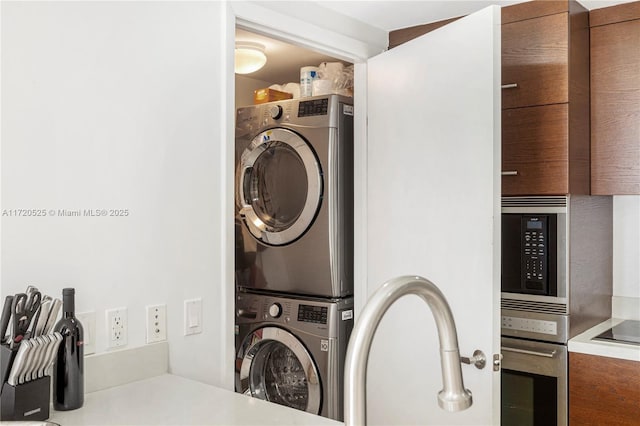 laundry area with stacked washing maching and dryer