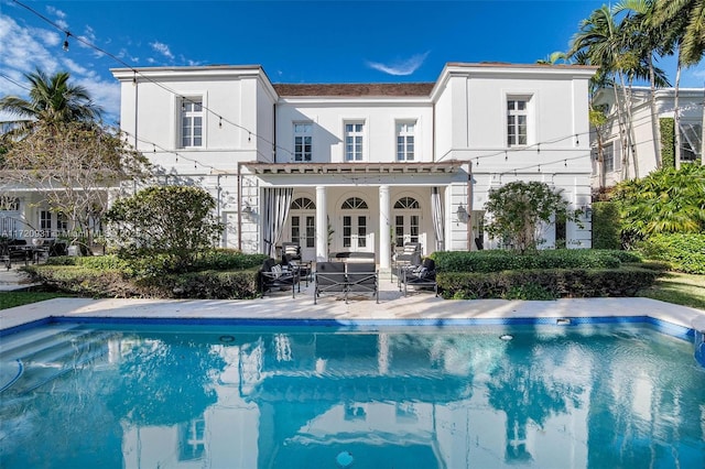 rear view of property featuring a patio area and french doors