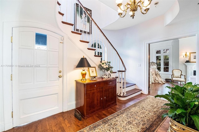 entryway featuring dark hardwood / wood-style flooring and a notable chandelier