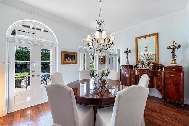 dining room with french doors, dark hardwood / wood-style floors, ornamental molding, and a healthy amount of sunlight