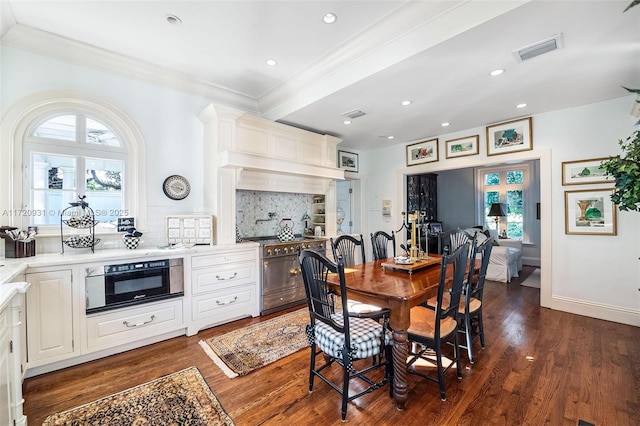 dining area featuring crown molding and dark hardwood / wood-style flooring