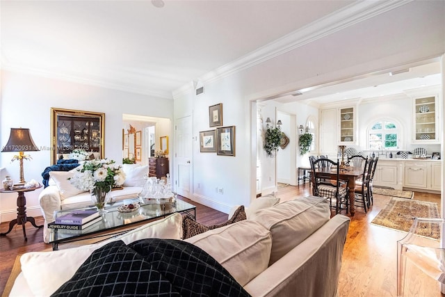 living room featuring hardwood / wood-style floors and ornamental molding