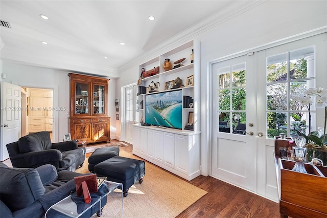 living room featuring dark hardwood / wood-style flooring and ornamental molding