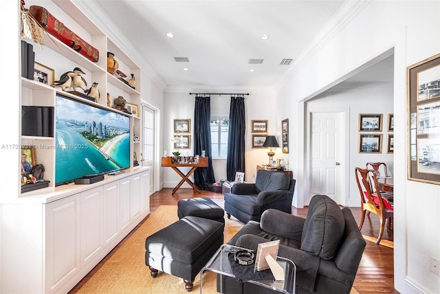 living room featuring crown molding and light hardwood / wood-style floors