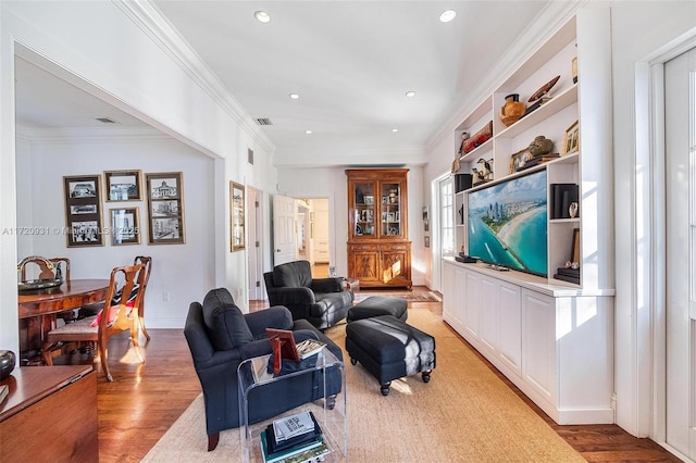 living room featuring hardwood / wood-style floors and ornamental molding