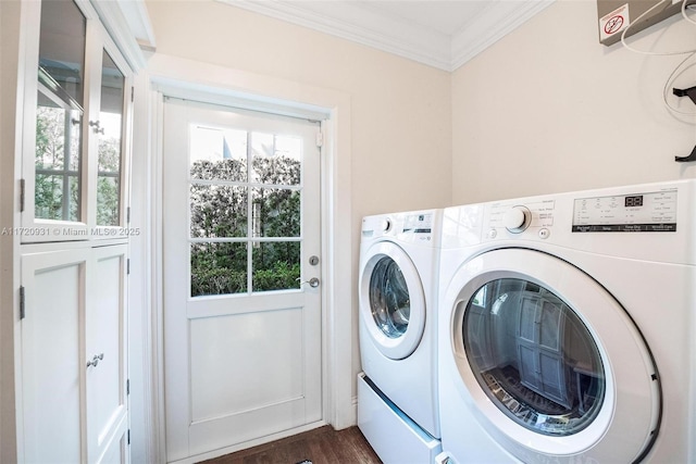 laundry area with dark hardwood / wood-style flooring, washing machine and dryer, and ornamental molding