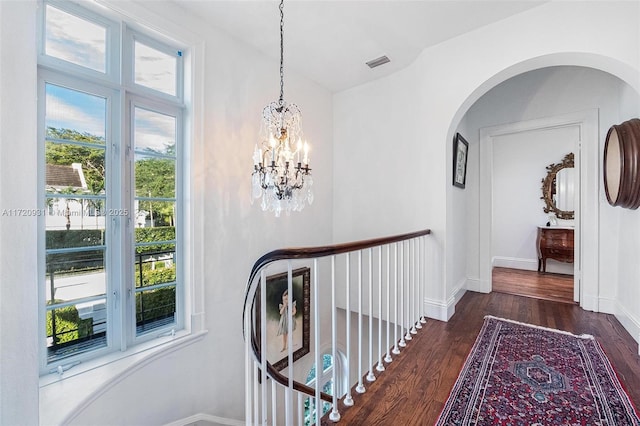 hall featuring a chandelier and dark hardwood / wood-style flooring