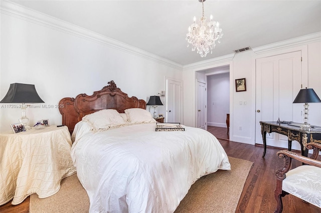 bedroom featuring dark hardwood / wood-style floors, crown molding, and an inviting chandelier