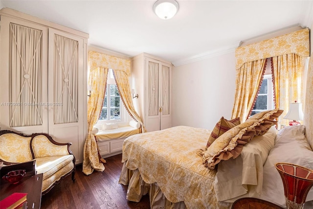 bedroom with crown molding and dark hardwood / wood-style floors