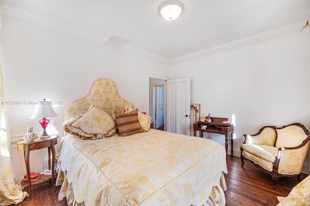 bedroom featuring crown molding and dark wood-type flooring