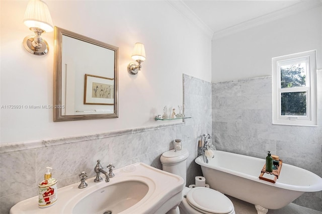 bathroom with crown molding, sink, tile walls, toilet, and a bathing tub