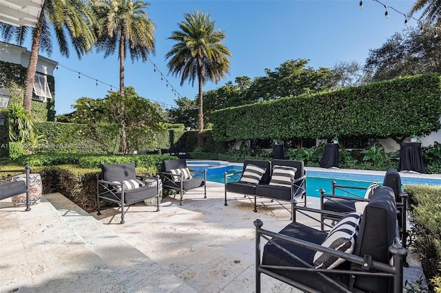 view of swimming pool featuring outdoor lounge area and a patio