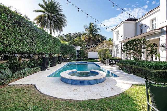 view of pool featuring an in ground hot tub and a patio area