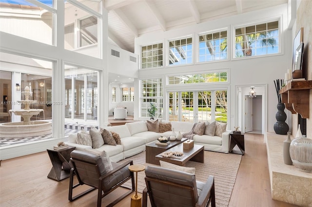 sunroom with beam ceiling and french doors