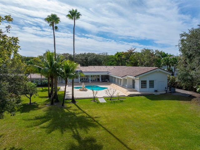 view of pool with a yard and a patio