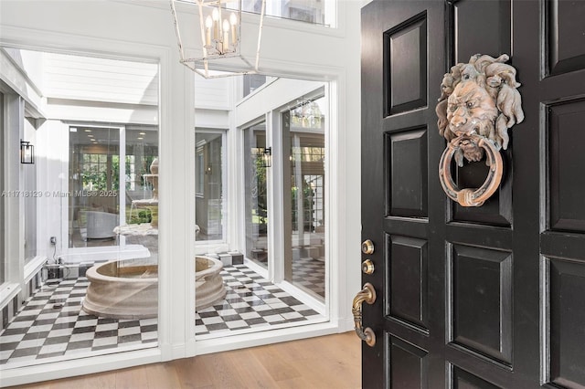 interior space featuring light hardwood / wood-style floors and a notable chandelier