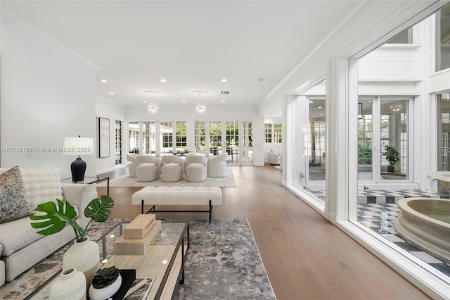 living room with crown molding, french doors, and wood-type flooring