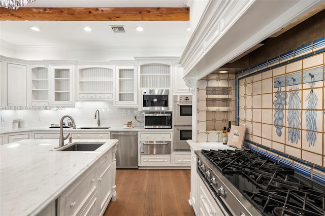 kitchen featuring sink, tasteful backsplash, light stone counters, white cabinetry, and stainless steel appliances