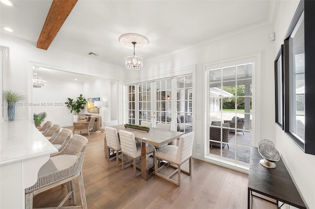 dining room with a chandelier, beam ceiling, hardwood / wood-style flooring, and ornamental molding