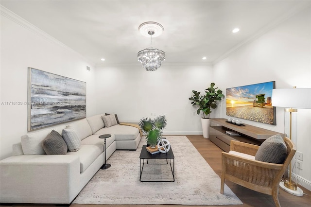 living room with light hardwood / wood-style floors, a notable chandelier, and ornamental molding