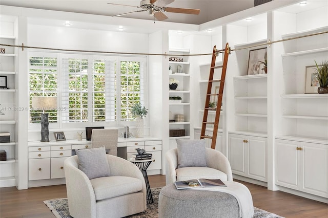 living area featuring dark hardwood / wood-style flooring and ceiling fan