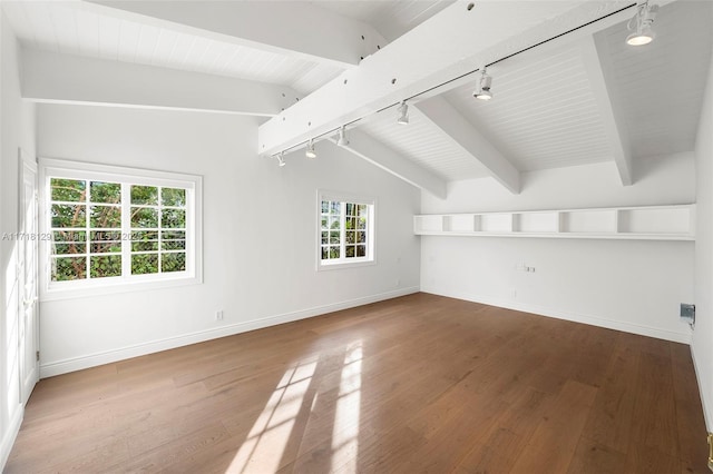 empty room featuring vaulted ceiling with beams, rail lighting, and wood-type flooring