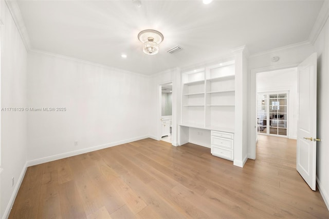 unfurnished bedroom with light wood-type flooring, built in desk, and ornamental molding